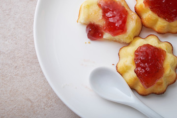 A portion of cottage cheese casserole with strawberry jam and peaches