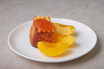 A portion of cottage cheese casserole with strawberry jam and peaches