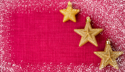 Fototapeta na wymiar The red Christmas day on the background image and gold stars on the background has spaces for text for the new year or merry Christmas.