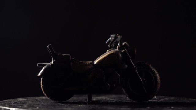 metal bike toy turntable  lighter dark background  cruiser bike