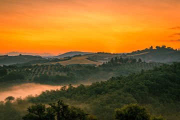 Beautiful Tuscany scenery with rolling hills at sunrise
