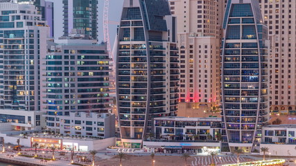 Fototapeta na wymiar Dubai Marina skyscrapers, port with luxury yachts and Marina promenade aerial day to night timelapse, Dubai, United Arab Emirates