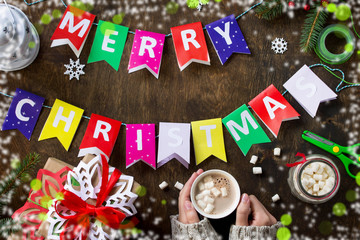 Merry Christmas background, xmas gift box, branch of a Christmas tree and decorations with light bokeh effect.