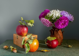 Still life with apples, a bouquet of asters and hazelnuts. Food. Vintage.