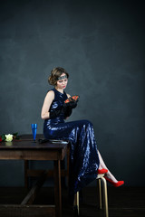 girl in evening blue dress with fortunetelling cards