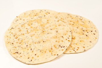 Pitta bread with seeds isolated on white