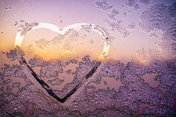 heart shape with beautiful patterns on frozen window