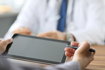 Advanced technology in the modern hospital. Patient puts an electronic signature on a health...
