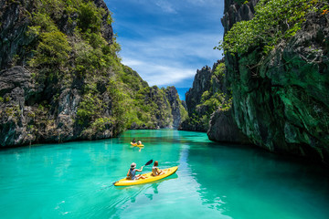 Naklejka na ściany i meble Palawan, Philippines, Tourists Kayaking and Exploring the Natural Sights Around El Nido