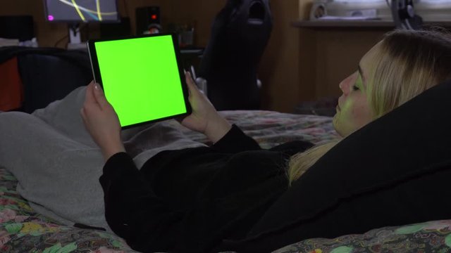 Woman Lying on Couch at Home Watching Tablet Green Screen