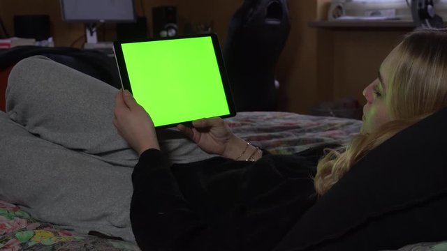 Woman Lying on Couch at Home Watching Tablet Green Screen