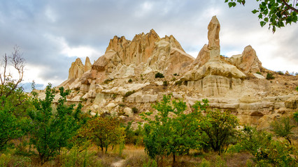 Fototapeta na wymiar Mountain landscape in Pigeon valley in Cappadocia, Turkey. Unreal rock formations of Cappadocia