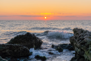 Colorful sunrise on a rocky seashore