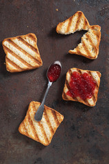 Toasted bread and one piece with jam