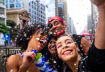 Girls taking selfie at street party parade, brazilian carnaval. Group of Brazilian friends in...