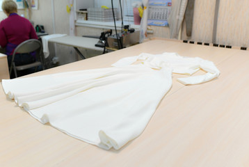 Fototapeta na wymiar seamstress sewing workshop thread fabric