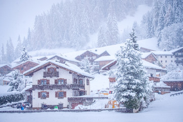 Winter landscape in the town of Neustift in the Stubai Valley in Austria. Tyrolean house amid heavy snow and fir trees