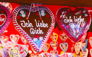 Heart shape Gingerbread cookies food on Christmas market in Europe in winter. German Night street...