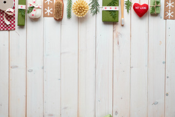 Christmas or New Year winter holiday eco friendly decorations with copy-space, craft paper boxes, eco friendly gifts. Geometric flat lay with gift boxes decorated with ribbon, cord and evergreens