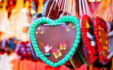 Heart shape Gingerbread cookies food on Christmas market in Europe in winter. German Night street...