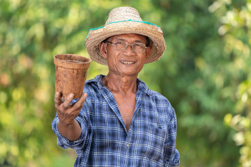 Fototapeta premium Asian farmer agriculture holding pot.