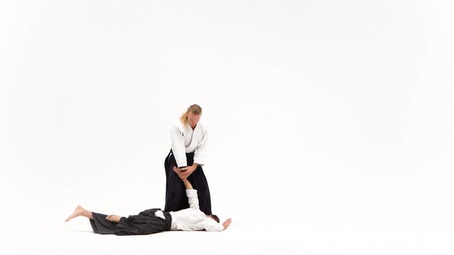 Two guys showing aikido using tanto. Isolated, white. Close up.