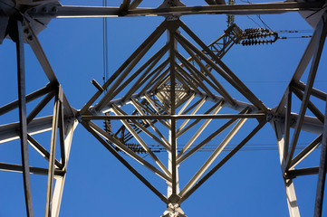 electricity pylon against blue sky