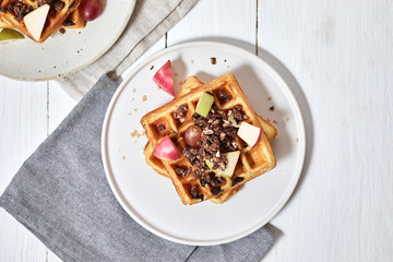 Homemade waffles with fruit and granola..