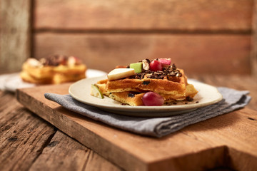 Homemade waffles with fruit and granola..