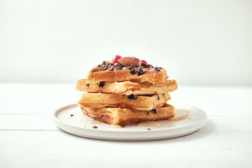 Homemade waffles with fruit and granola..