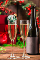 champagne and new year, christmas or noel (champagne glass, sparkling wine and gifts on the table) menu concept. food background. copy space. Top view