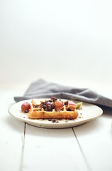 Homemade waffles with fruit and granola..