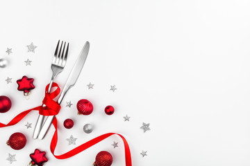 Serving for Christmas dinner with cutlery and holiday decorations top view. Winter table setting....