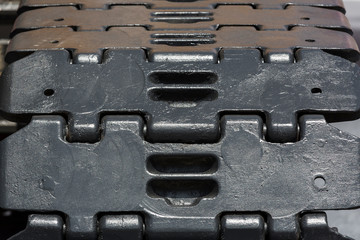 Caterpillars metal parts of the excavator shot close-up