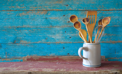 set of vintage wooden spoons in a mug, kitchen utensils, cooking,food, culinary concept, flat lay with good copy space