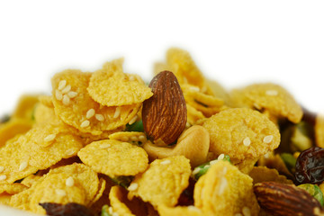 Cornflakes with dried fruits and nuts isolated on white background.