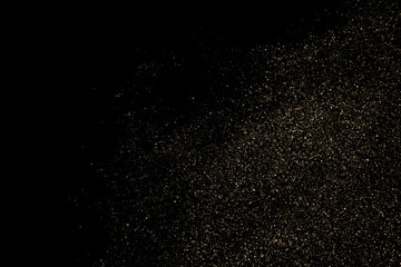 Fototapeta na wymiar Gold glitter particles texture. Golden dust isolated on black background