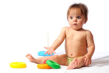 Surprised funny baby playing with toy