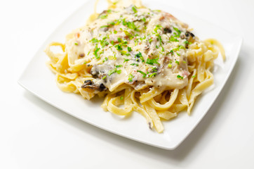 Tagliatelle pasta with smoked pulled ham hock and roasted mushrooms in a cheese sauce
