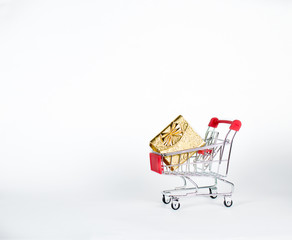 Shopping cart with gokden gift box white background