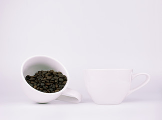 Coffee beans in white coffee cup over white background.