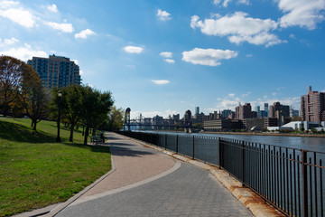 Empty Walkway at Rainey Park along the East River in Astoria Queens New York and next to the Midtown Manhattan Skyline
