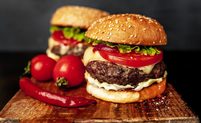 two Tasty grilled burgers on a stone background