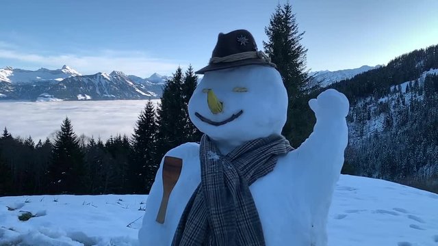 snow man up in the swiss alps
