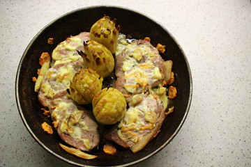 Pan with baked meat, potato, onion, carrot on white background