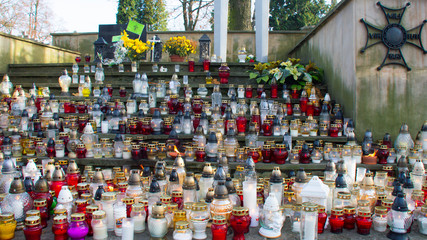 Monument and candles in the cemetery. All Saints Day in Poland. A lot of funeral candles.