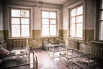 Bedroom in abandoned kindergarten in destroyed village of Kopachi, 10 km Chernobyl NPP alienation...