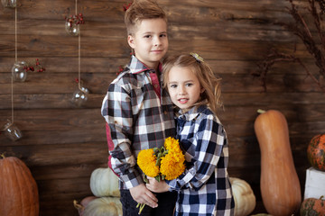 Fototapeta premium Boy and girl with bouquet of yellow flowers. love concept