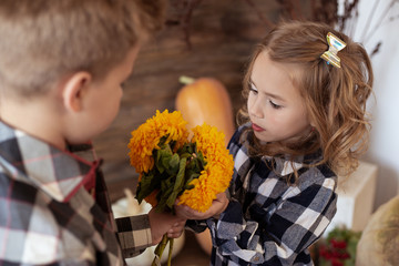 love concept, warm autumn, boy present girl bouquet of yellow flowers.