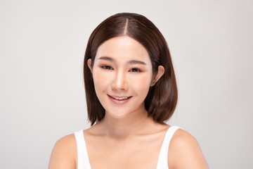 Beautiful Asian woman looking at camera smile with clean and fresh skin Happiness and cheerful with positive emotional,isolated on gray background,Beauty and Cosmetics Concept